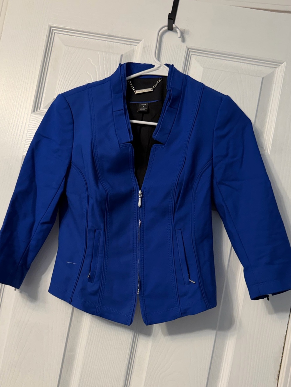 White House Black Market blazer features a chic structured stand collar and tail